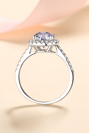 Silver pavé halo solitaire ring with a large purple center stone and diamond accents on the band.