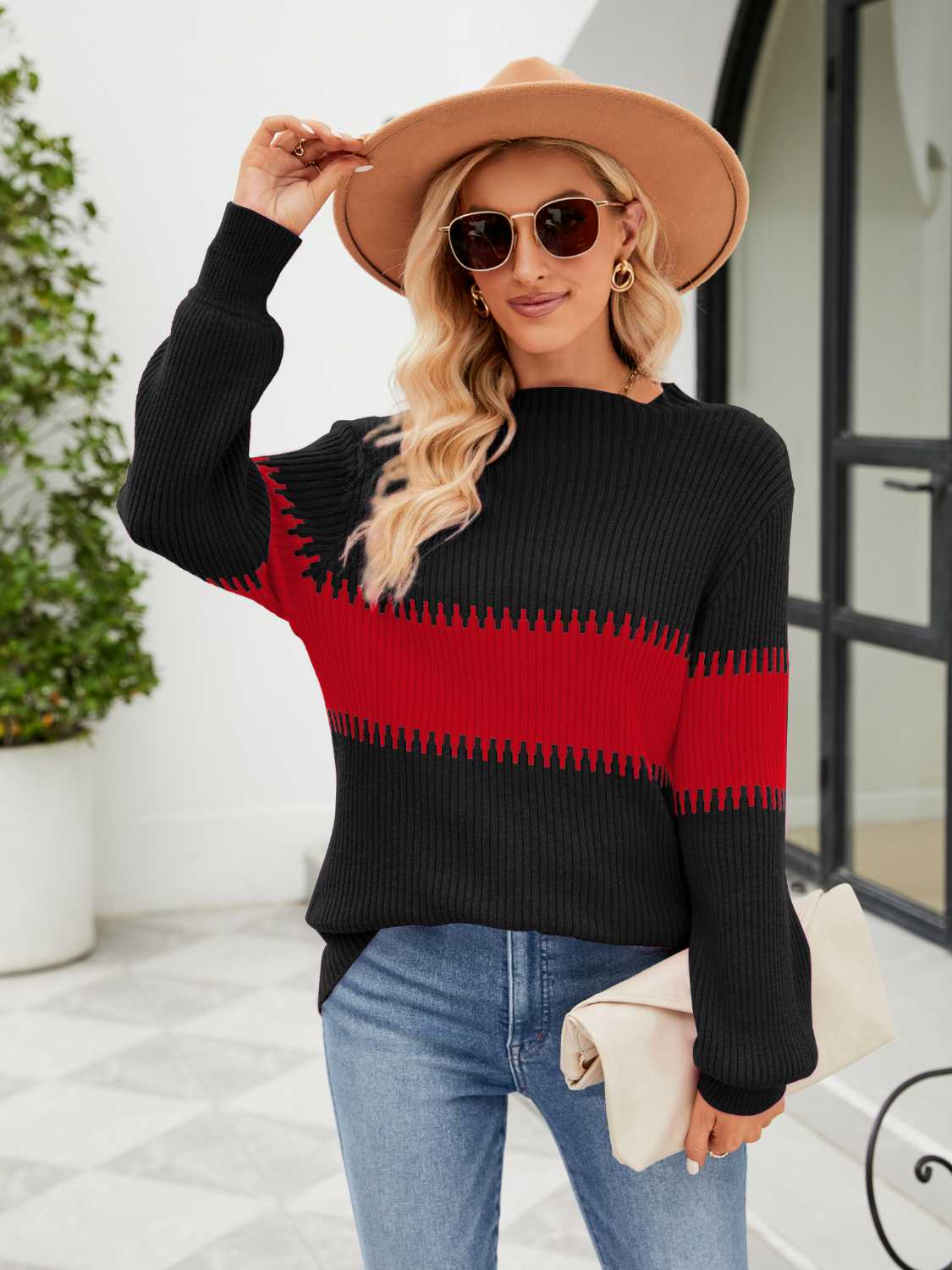 Colorblock ribbed sweater in black and deep red with a horizontal stripe detail.