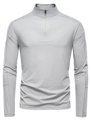 Gray performance zip-neck tee with structured shoulders and long sleeves.