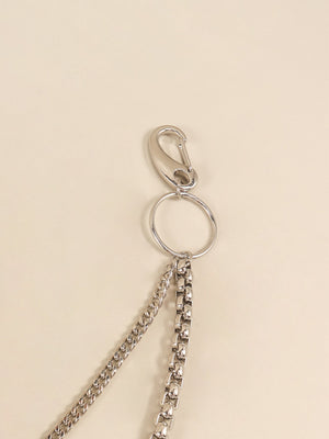 Silver double-strand chain pant accessory with carabiner clip and ring detail.