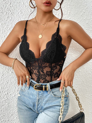Black lace corset bodysuit with scalloped trim and adjustable straps, styled with jeans.
