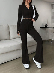 Black ribbed knit flare co-ord set with zip neck crop top and high waist pants.