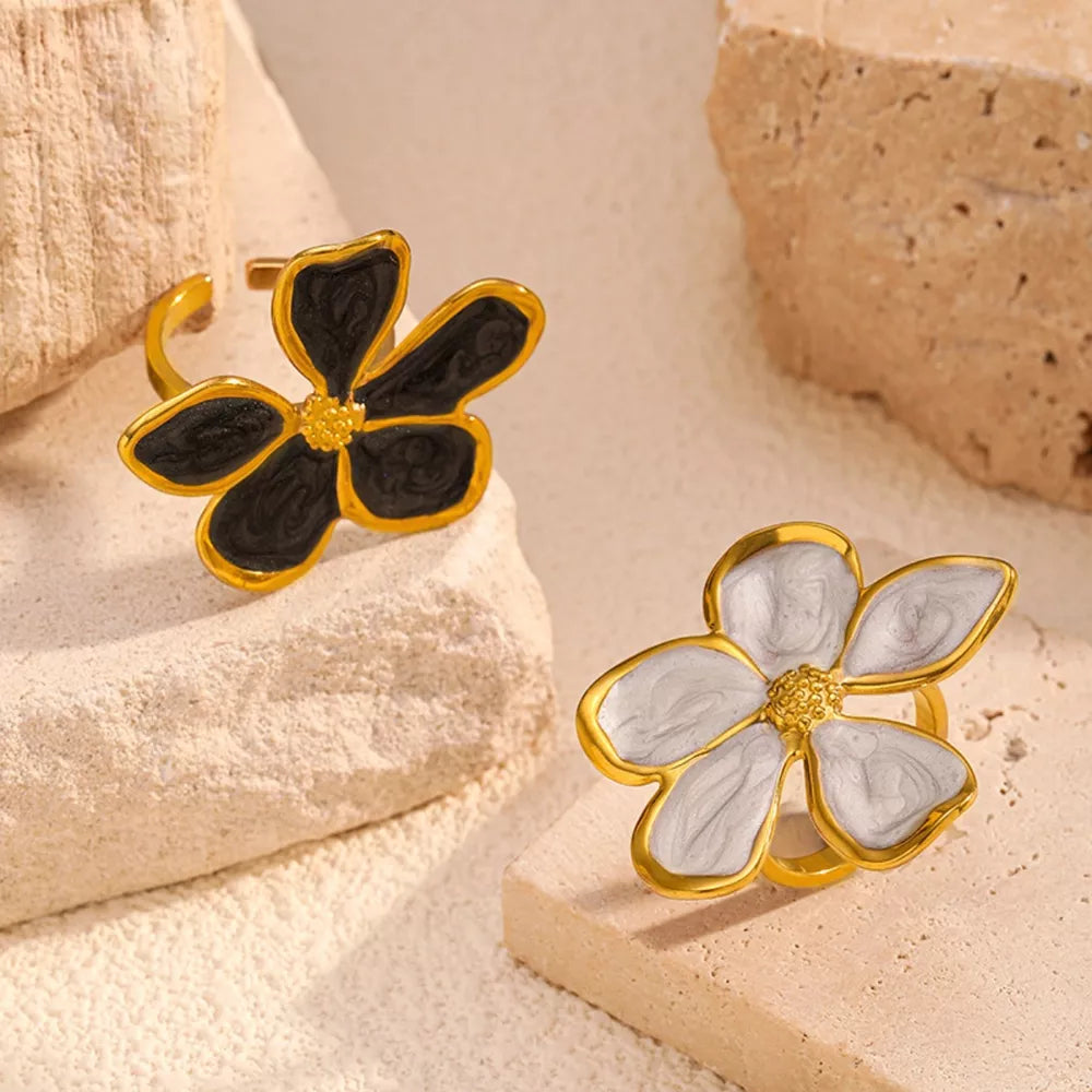 Gold open ring with black and cream floral design