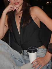 Black halter ruched cami top with deep V-neck and fringe detail.