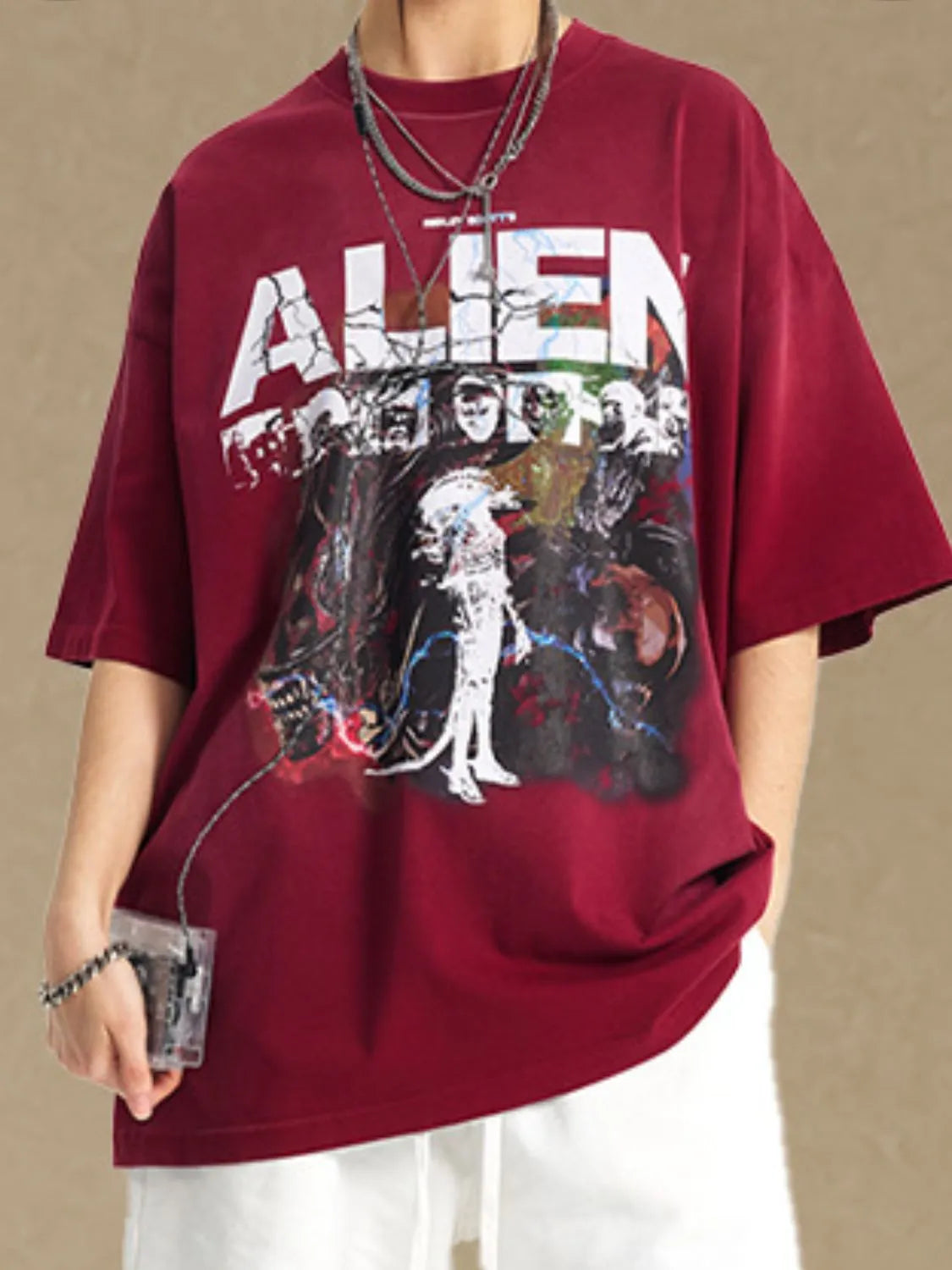 Burgundy oversized tee with a graphic alien print and distressed "ALIEN" text.