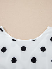 White polka dot blouse with a scoop neckline.