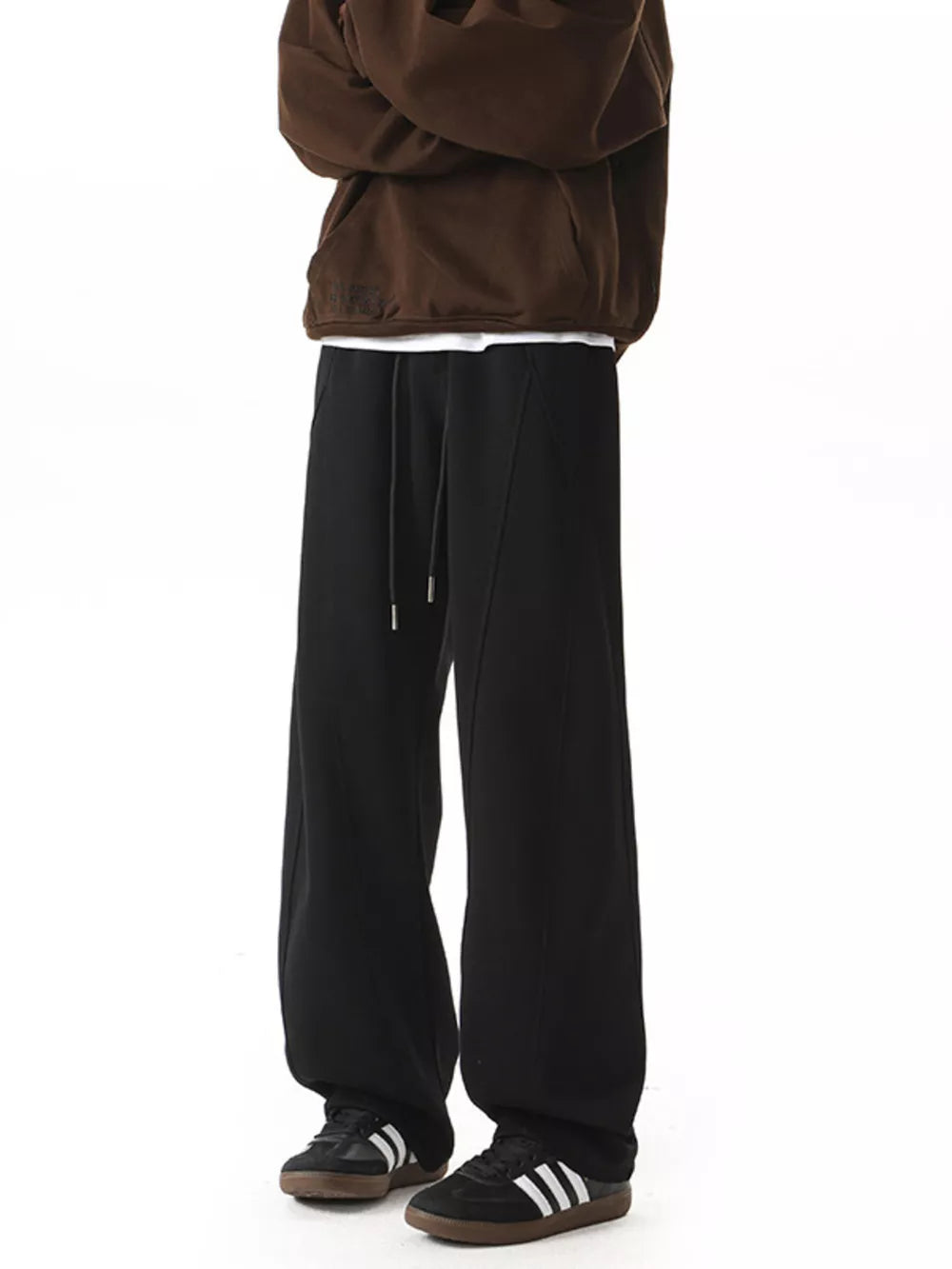 Men's black drawstring wide-leg pants with a relaxed fit.
