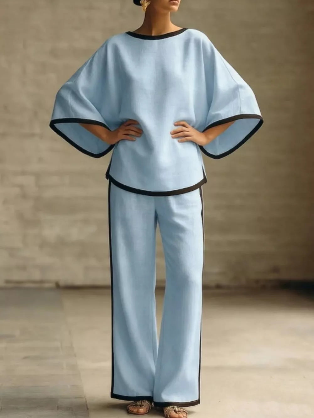 Blue two-piece set with boat neck top and wide leg pants, featuring contrast black trim.