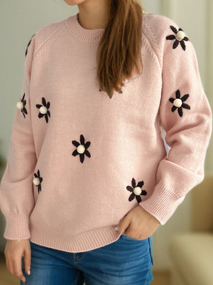 Apricot knit sweater with embroidered floral details and raglan sleeves.
