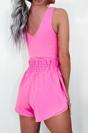 Fuchsia pink active romper set with scoop neck tank and elastic waist shorts.