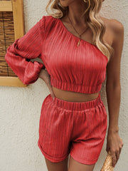 Orange-red textured one-shoulder crop top and shorts set with balloon sleeves