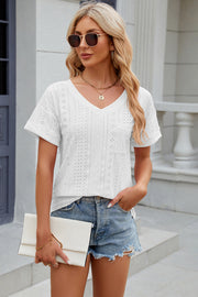 White perforated v-neck t-shirt with rolled sleeves and a chest pocket.
