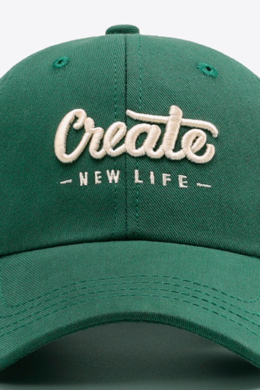 Green baseball cap with embroidered "Create New Life" text