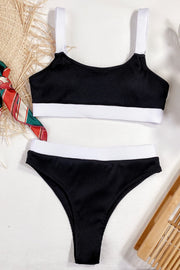Black ribbed high-waist bikini set with white trim and straps.