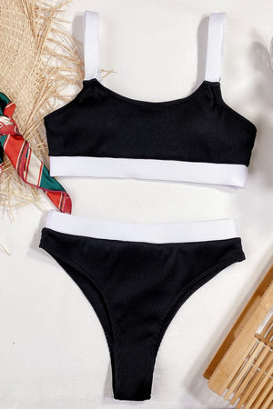 Black ribbed high-waist bikini set with white trim and straps.