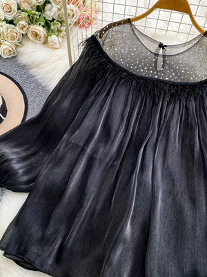Black sheer mesh blouse with rhinestone embellishments and feather trim.