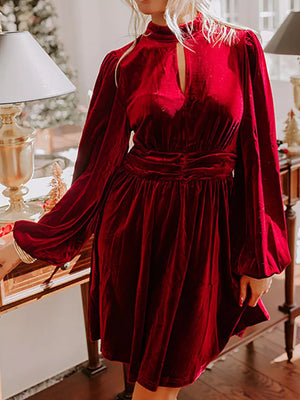 Burgundy velvet mock neck dress with keyhole detail and balloon sleeves.