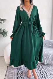 Forest green midi dress with lace trim V-neck, tie waist, and ruffled hem.