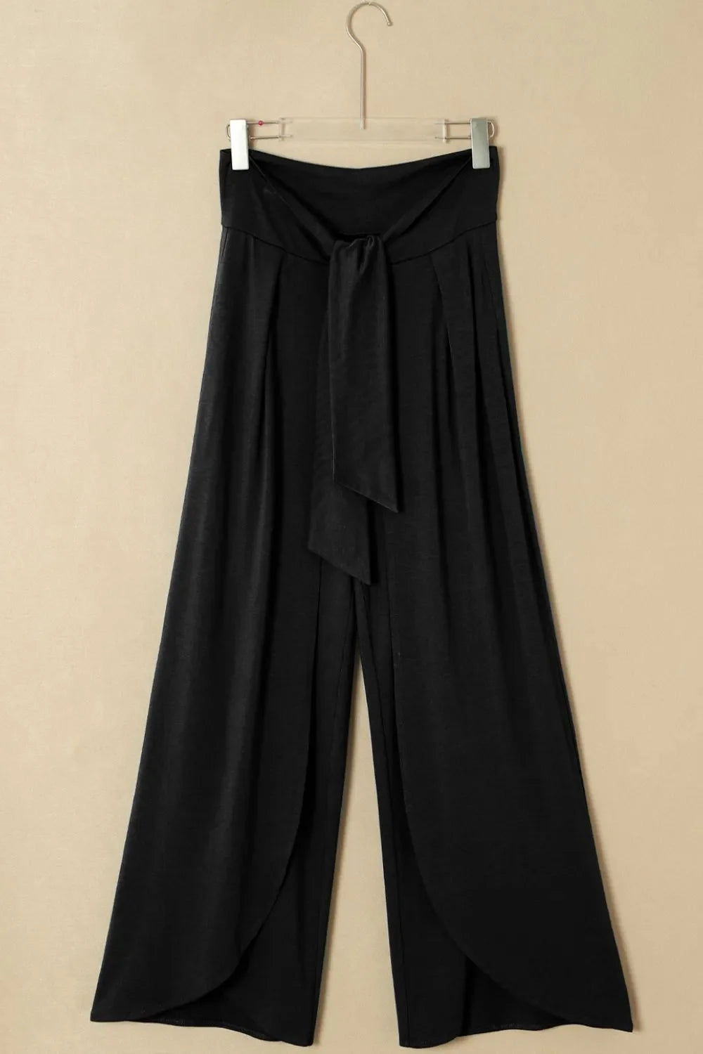Black wrap-front palazzo pants with tie waist and slit hem