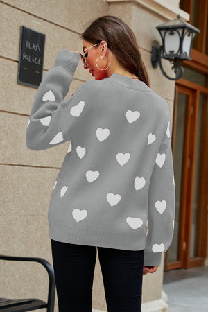 Gray knit sweater with white heart pattern and balloon sleeves.