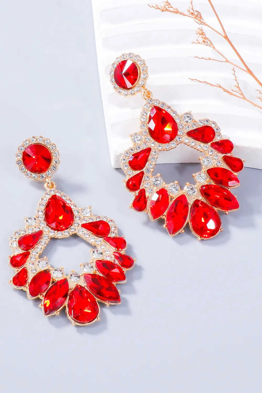 Red crystal drop earrings with floral-inspired design and gold-tone alloy setting.