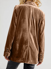 Camel velvet double-breasted blazer with patch pockets and button cuffs.