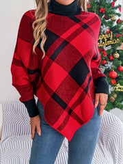 Asymmetric tartan turtleneck poncho sweater in deep red acrylic with black plaid pattern.