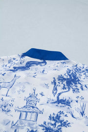 White polyester shirt with blue toile print, V-neck, and royal blue collar detail.