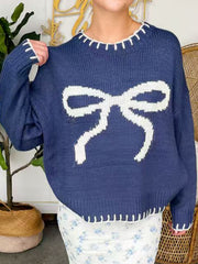 Navy knit sweater with white bow detail and contrast stitching.