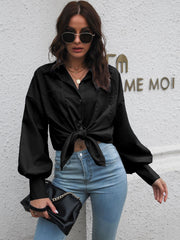 Black oversized poplin blouson sleeve shirt with button front and tie knot detail.