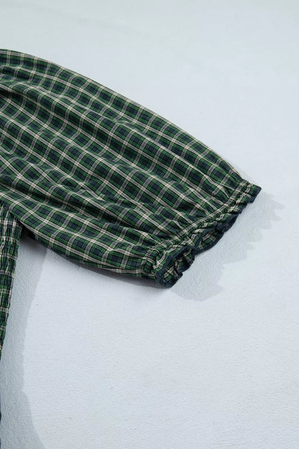 Plaid maxi dress with ruffled hem detail and short sleeves.