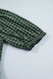 Plaid maxi dress with ruffled hem detail and short sleeves.