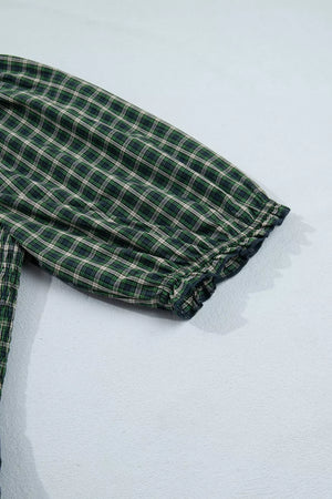 Plaid maxi dress with ruffled hem detail and short sleeves.