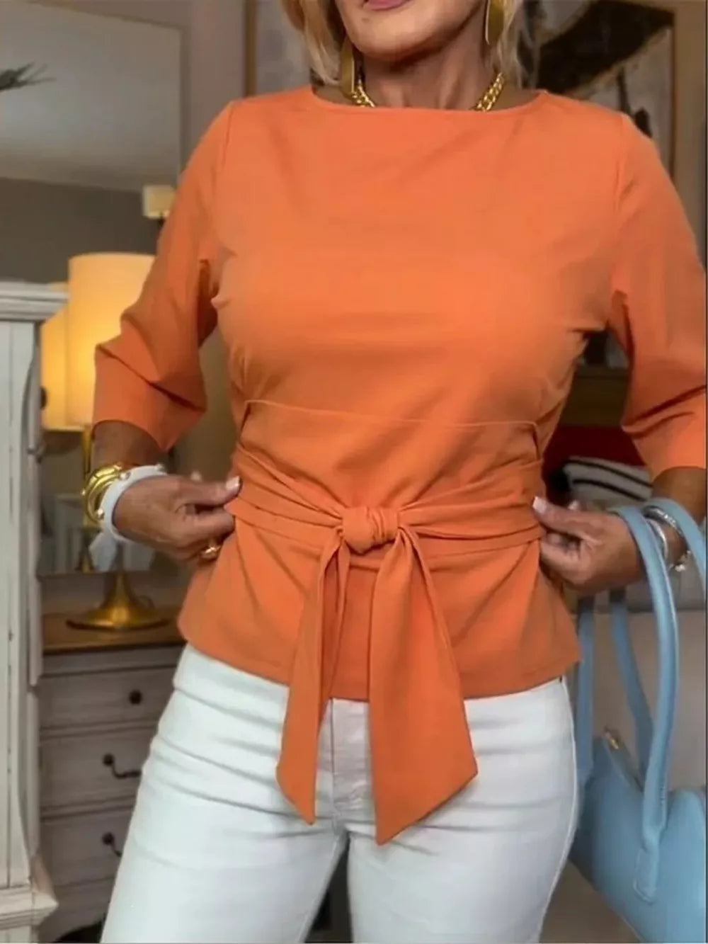 Orange 3/4 sleeve t-shirt with a chic tied waist detail.