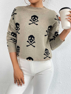 Khaki knit sweater with allover black skull and crossbones print, drop shoulder, and crew neck.