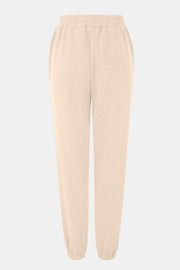 Relaxed-fit cuffed sweatpants in pastel yellow with elastic waistband and pockets.