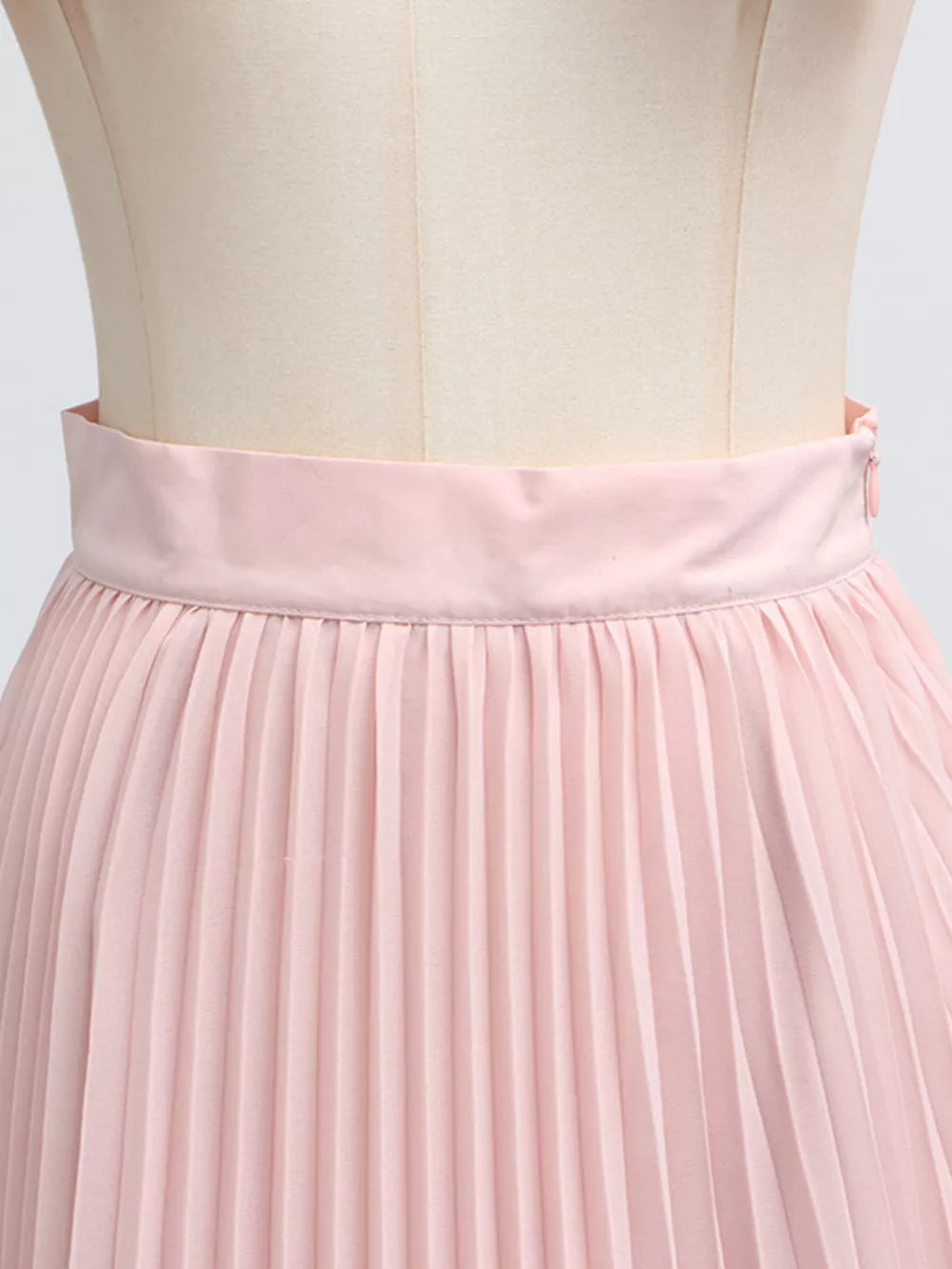 Pink pleated skirt suit with a frill collar detail and balloon sleeves.