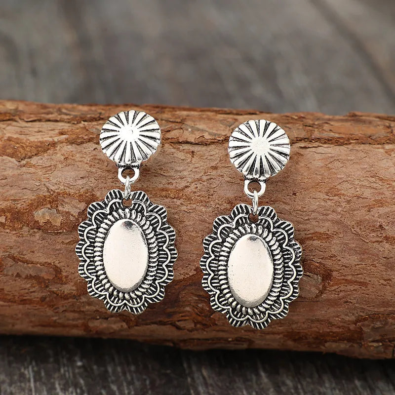 Antique silver scalloped oval drop earrings with sunburst studs.