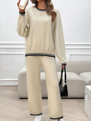 Beige knit lounge set with black ribbed trim on neckline, hem, and cuffs.