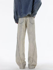 Men's beige wide leg jeans with distressed wash and visible stitching detail