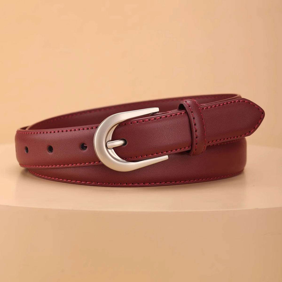 Red cowhide leather belt with silver buckle and contrast stitching