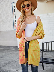Colorblock leopard knit duster cardigan in acrylic with button front and pockets.