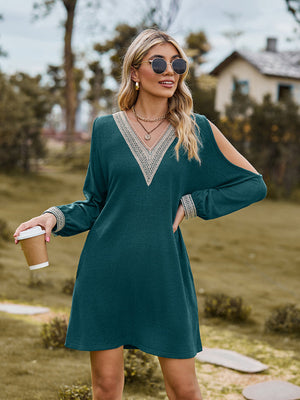 Teal cold shoulder mini dress with lace trim neckline and cuffs.