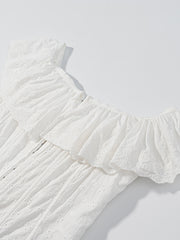 White eyelet tank top with ruffled neckline and delicate floral embroidery.