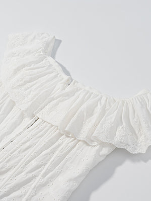 White eyelet tank top with ruffled neckline and delicate floral embroidery.