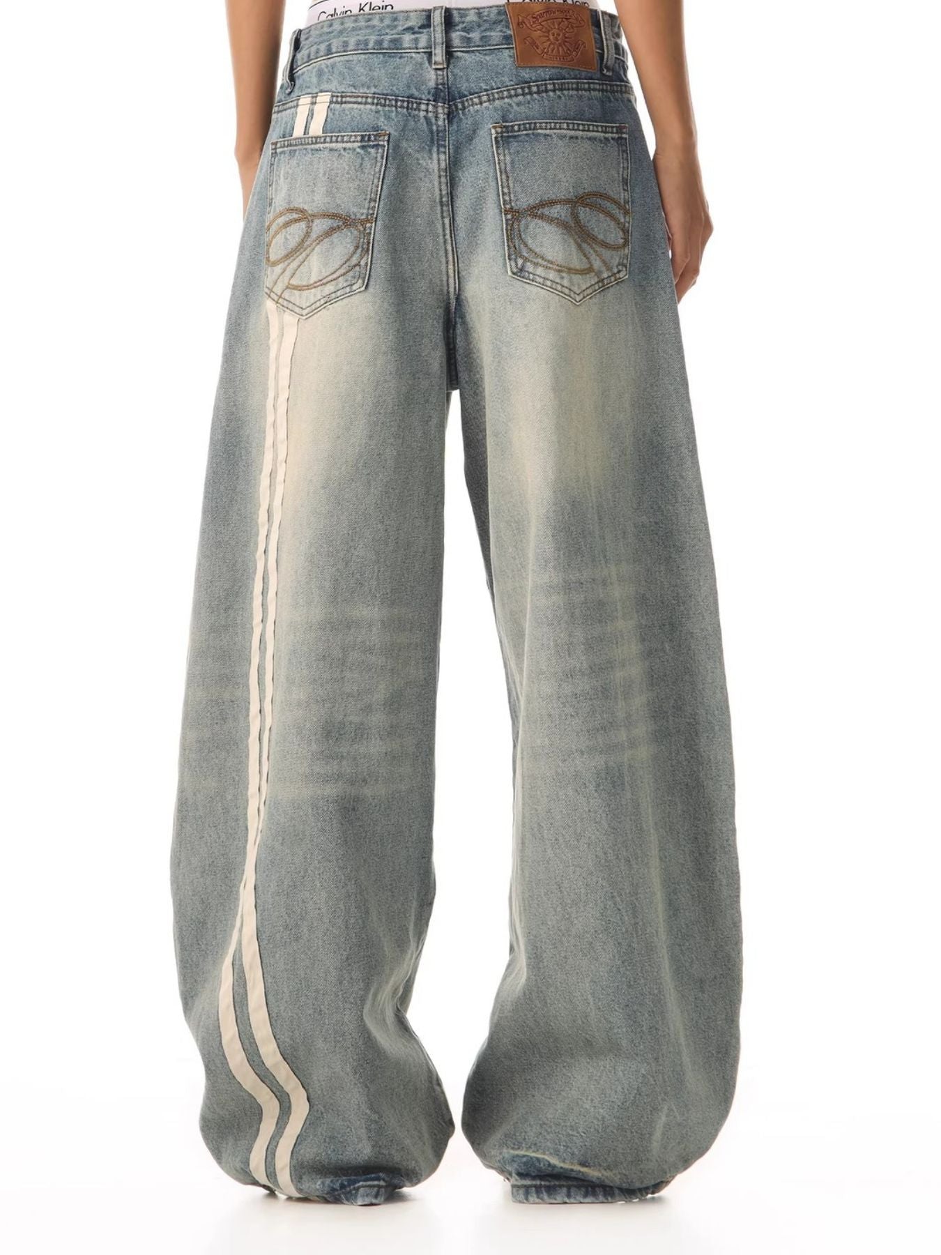 Men's vintage wide leg jeans in blue denim with white stripe detail and baggy fit.