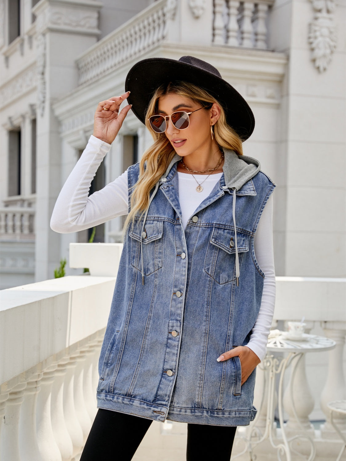 Hooded denim vest in dusty blue with button-down closure and drawstring hood.