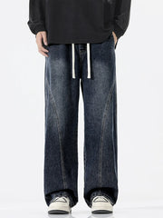 Relaxed fit dark wash wide-leg jeans with drawstring waist and contrast stitching.