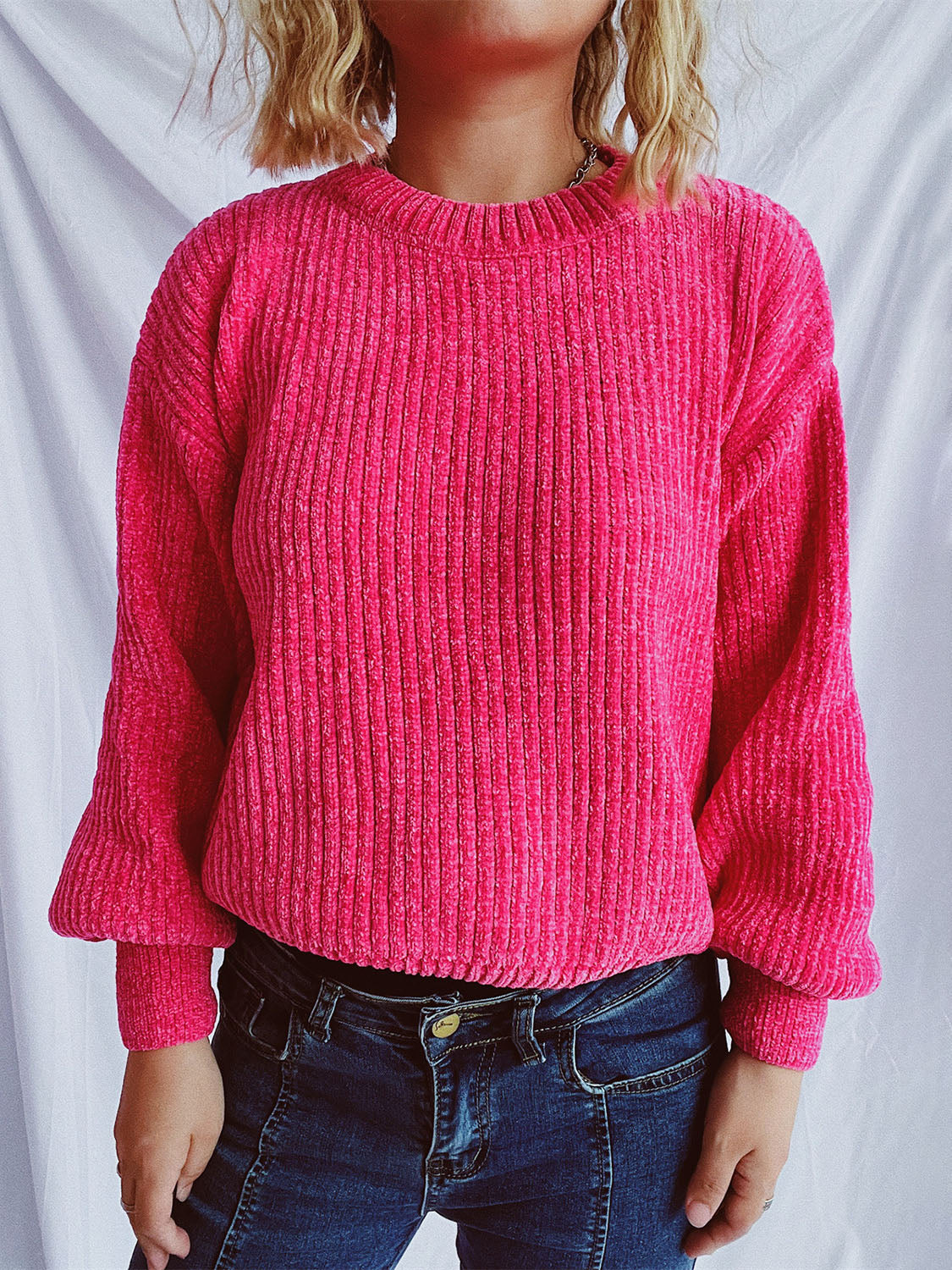 Textured ribbed knit crewneck pullover sweater in bright pink with balloon sleeves.