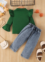 Green ribbed top with ruffle sleeves and light wash jeans with elastic waistband.